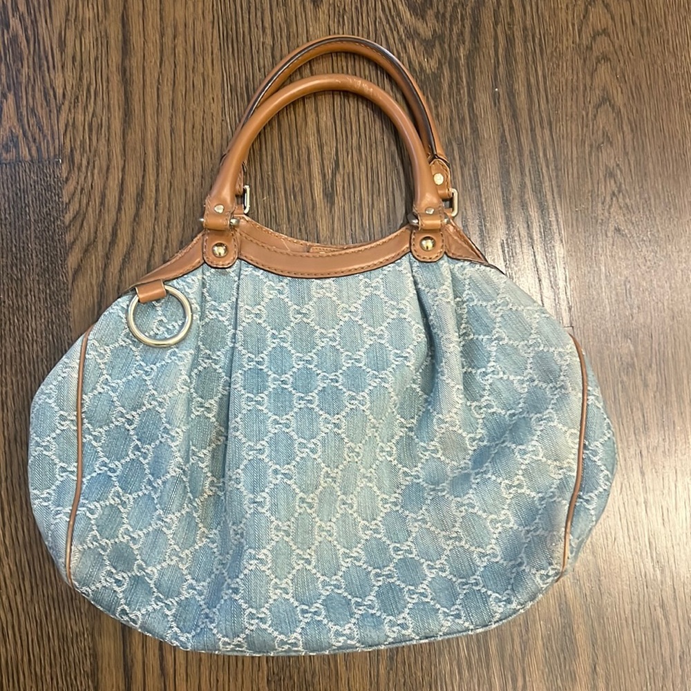 Denim gucci bag in great condition. Brown leather handles